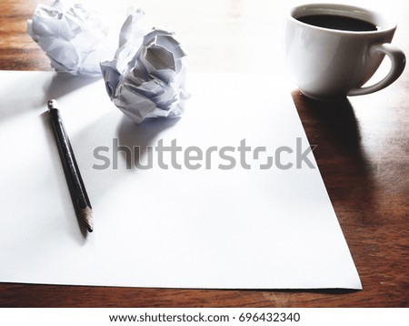 Businesses have both been successful and fail. The picture of fail work, paper, pencil and a cup of coffee above old  wooden table.