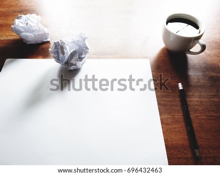Businesses have both been successful and fail. The picture of fail work, paper, pencil and a cup of coffee above old  wooden table.