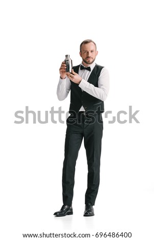 handsome bartender with classical metal shaker isolated on white Royalty-Free Stock Photo #696486400