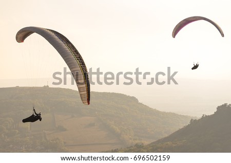 Paragliding in the air at sunset