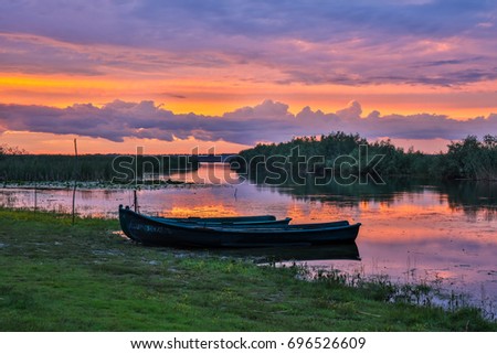 Boats anchored to the shores of the delta at sunset