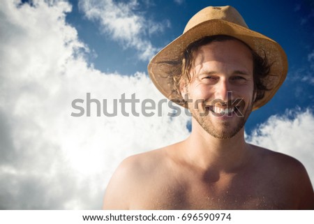 Handsome man wearing hat  against view of beautiful sky and clouds