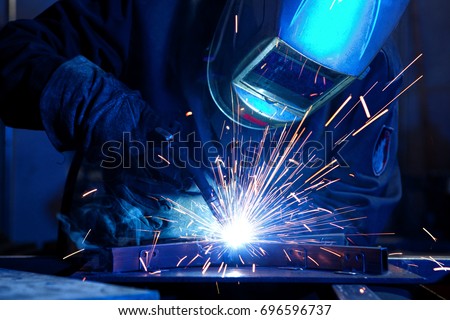 Welder erecting technical steel. Industrial steel welder in factory technical Royalty-Free Stock Photo #696596737