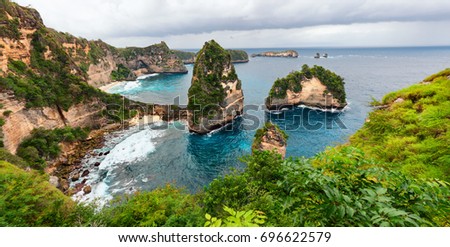 Sea coast view with little house standing on the high cliff bring above sea and little rocky islets. Atuh beach, Nusa Penida island. Popular travel destination on Bali holidays. Indonesian background.
