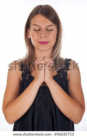 Picture of a religious young woman praying on isolated background