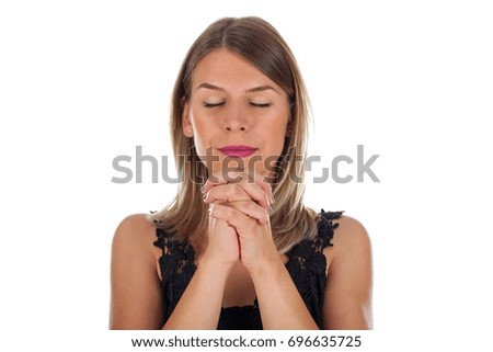 Picture of a religious young woman praying on isolated background