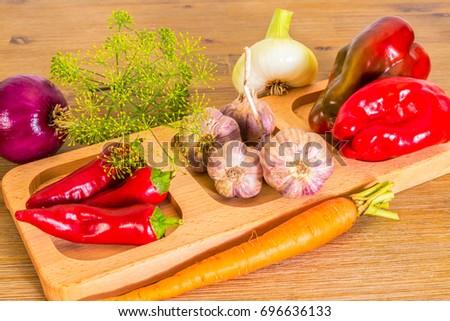Exposition of fresh organic vegetables, Healthy food, Healthcare, carrot,garlic, onion, walnuts, red onion, red pepper, dill, fennel, red hot chili pepper on wooden table.