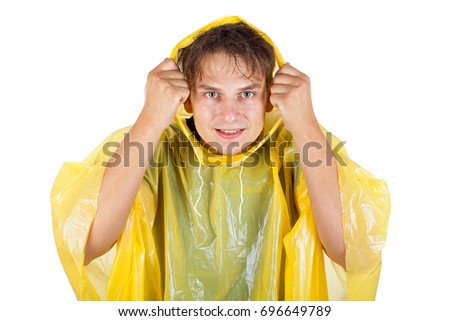 Picture of a caucasian young man wearing a yellow raincoat, posing on isolated background
