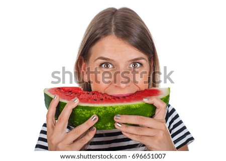 Picture of a hungry young woman eating a big slice of delicious watermelon on isolated background