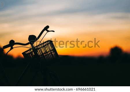 Silhouette picture of bicycle in the evening,the sunset light for exercise and relax.