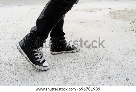 Legs go forward with Black Sneakers. Comic Effect  Royalty-Free Stock Photo #696701989