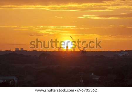 The sunset view with a crane over the Sun in Jacksonville city (Florida).
