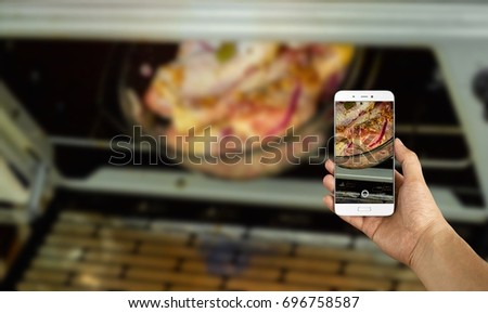 man taking a picture of raw chicken drumstick using a smartphone, point of view shot