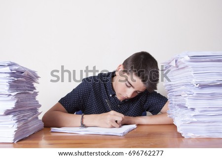 child student on the desk with stacked papers