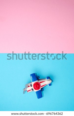 Flat lay design of travel concept with plane on blue background with copy space.