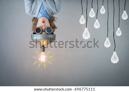 Portrait of child in classroom. Kid with toy virtual reality headset in class. Success, idea and innovation technology concept. Back to school Royalty-Free Stock Photo #696775111