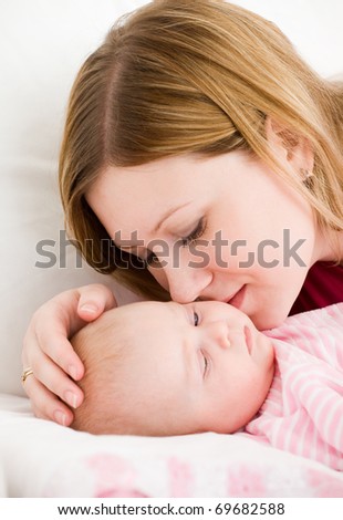 Young mum embraces the falling asleep chest baby