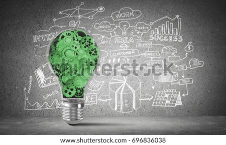 Lightbulb with multiple gears inside placed against business-plan information sketched on grey wall. 3D rendering.