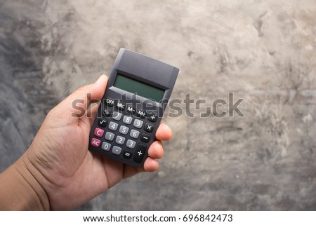 Business background image: Gray tone wall with calculator
