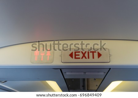 Exit and toilet sign on plane