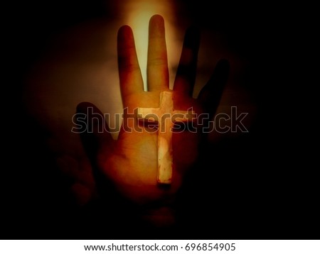 Close up palm hand with cross in darkness, picture with shade decoration process