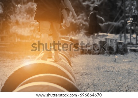 Kids playing in the playground. Running on tires.selective focus.vintage color
