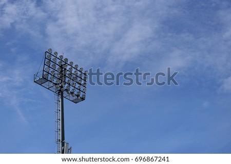 Stadium floodlight with metal pole with blue sky in the football stadium.