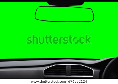 Windshield and rear view mirror ,View inside the car with green scree Isolated on background with clipping path.