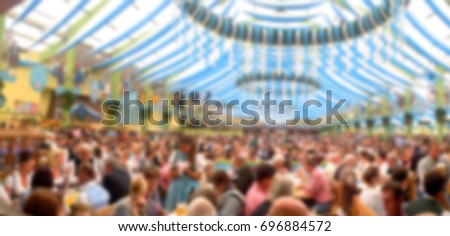 Blur_People enjoy live music and drinking beer during October festival in munich (München), Germany Royalty-Free Stock Photo #696884572