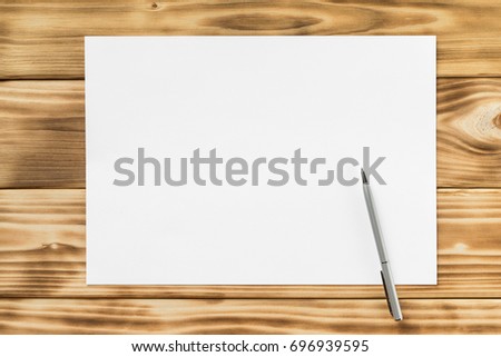 Mockup of white a4 paper list and pen at textured wooden table background.