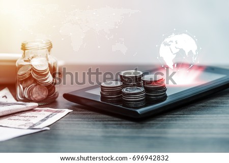 Technology network online banking and internet banking and networking people concept, Save account banking for finance business concept, Laptop with coin money on business office table Royalty-Free Stock Photo #696942832