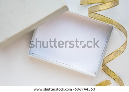 open empty gift box on white table. Colorful Gift box with ribbon bow present on holiday
