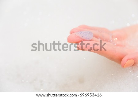 Body scrub with exfoliating particles. Selective focus. Closeup Royalty-Free Stock Photo #696953416