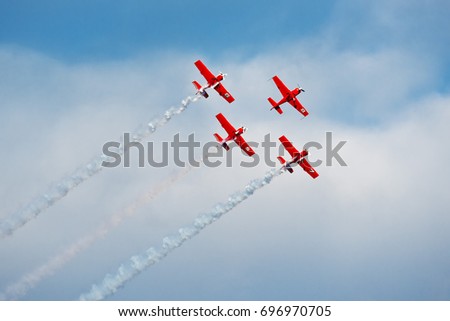 Formation of planes of the blue cloudy sky during the airshow. Royalty-Free Stock Photo #696970705