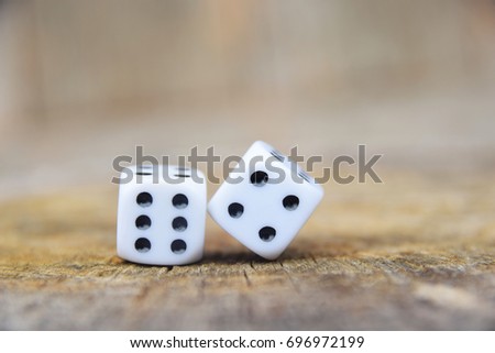 Dice enumeration number ten with a wooden background