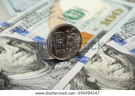 Russian one ruble coins and usa one hundred dollar banknotes