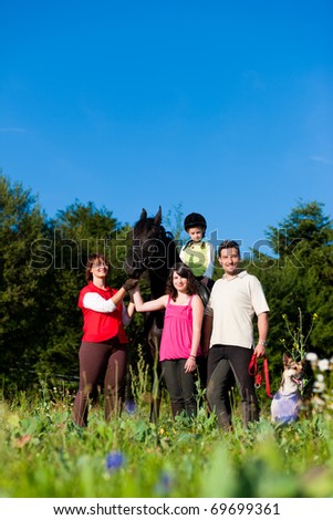 Family with children posing with a horse, one child riding the animal
