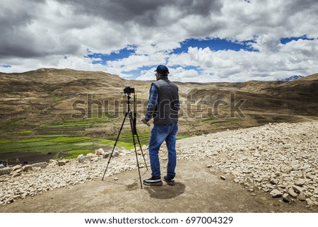 a photograpaher taking pictures in a valley