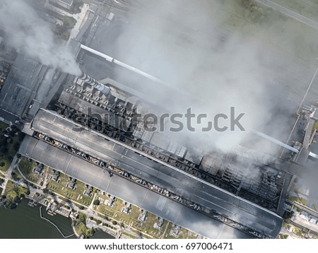 Working power station with steaming chimneys. It uses coal fuel. Top view panoramic photo. Horizontal.