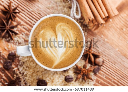 A cup of delicious coffee on a background of spices. good morning

