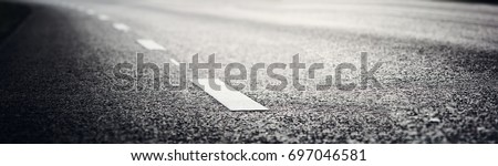 black asphalt road and white dividing lines Royalty-Free Stock Photo #697046581