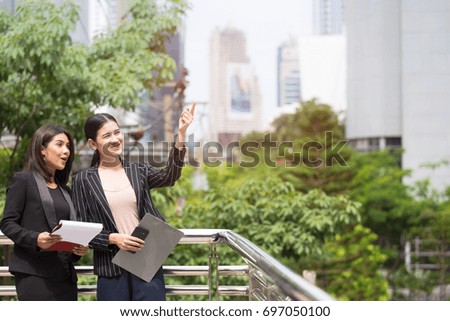 Two Businesswomen talking and discussing which Having Informal Meeting In the Office