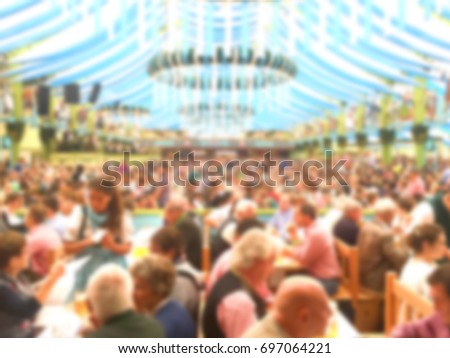 Blur_People enjoy live music and drinking beer during October festival in munich (München), Germany Royalty-Free Stock Photo #697064221
