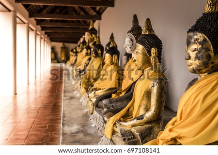 Picture Golden Buddha sitting lined up with each other.And is sacred to the Buddhist worship and pray. in thailand.
