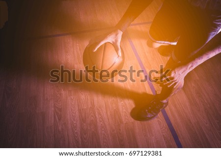 Basketball player in action with basketball court