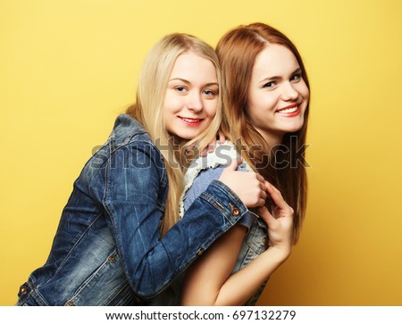 lifestyle and people concept: Two young girl friends standing to
