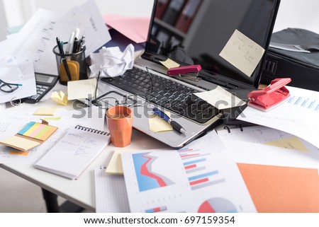 Messy and cluttered office desk Royalty-Free Stock Photo #697159354