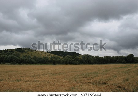 Rural scene with a field just before storm