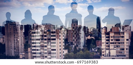 Colleagues standing over white background against trees amidst buildings in city