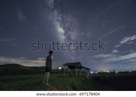 man take photo in green fields and milky way 
